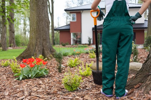 Worker applying landscaping safety procedures with protective equipment